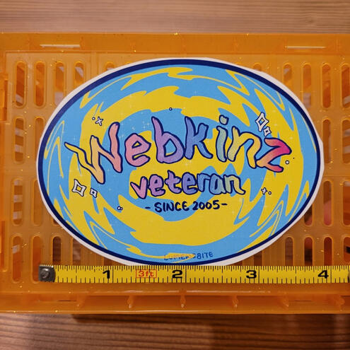 A photo of an oval-shaped Webkinz sticker.