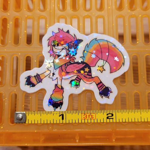 A photo of a holographic sparkledog sticker.